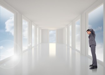 Fototapeta premium Composite image of thinking businessman scratching head