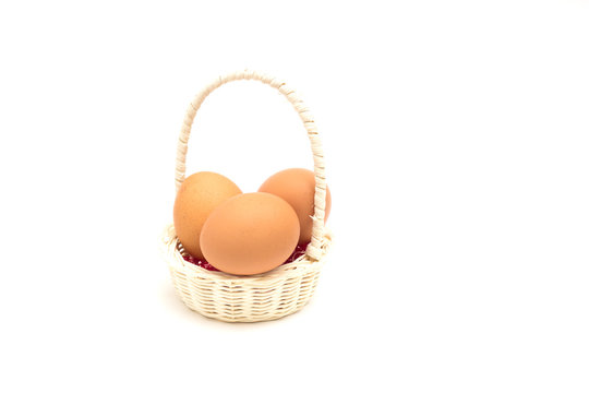 a basket with eggs on a white background
