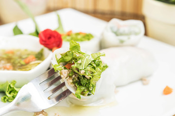 Fork with vietnamese chicken spring rolls.