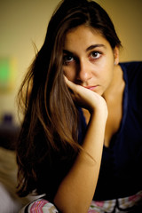 Young woman posing and thinking in the dark