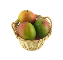 Ripe mango in a wicker basket isolated close up