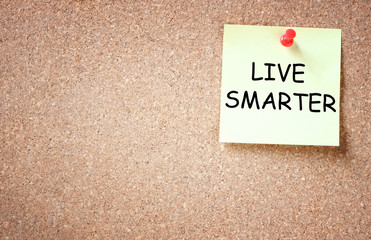 live smarter concept. memo note pinned to corkboard