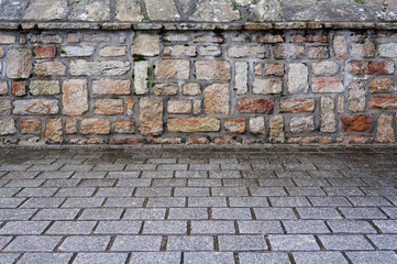 Hintergrund Granitpflaster und Natursteinmauer