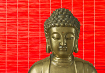 Golden Buddha is on the red background