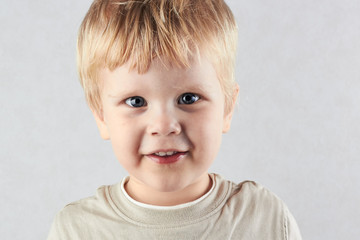 Naklejka premium handsome blond boy Looking At Camera. Positive human emotion