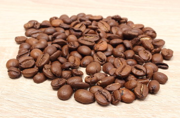 Heap of coffee on wooden background