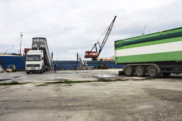 Truck loading grain on ship