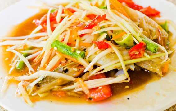 Closeup a dish of papaya spicy salad