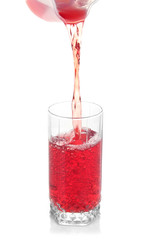 Juice pouring into glass isolated on white