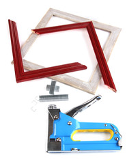 Construction stapler and wooden frames isolated on white