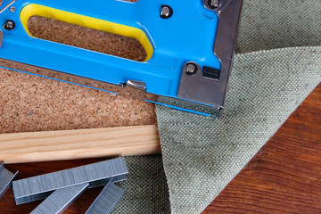 Construction stapler with staples and cork board