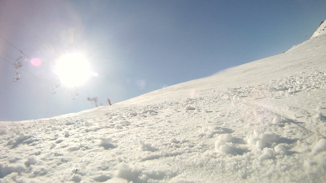 Alpine skier skiing short swings on ski slope