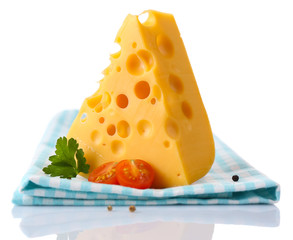 Piece of cheese and tomatoes,on color napkin, isolated on white