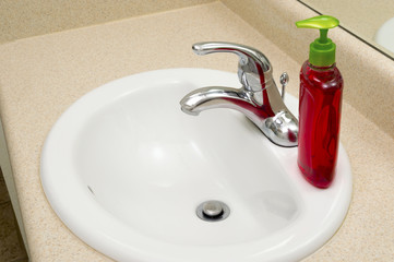 Close Up Of Bathroom Sink With Liquid Soap