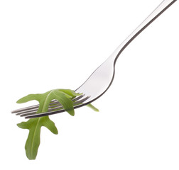 Fresh rucola  salad on fork isolated on white background cutout.