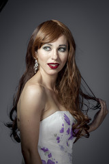 Naklejka premium Beautiful sexy woman with elegant long red shiny hair , hairstyl