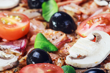 filling pizza with olives and tomatoes