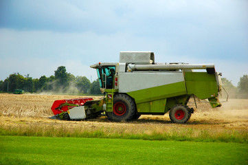 Combine harvester at work harvesting a field of wheat.