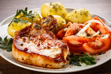 Grilled steak, boiled potatoes and vegetable salad