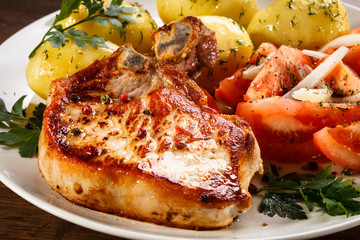 Grilled steak, boiled potatoes and vegetable salad