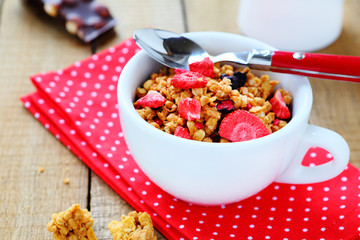 full cup of muesli with dried strawberry slices