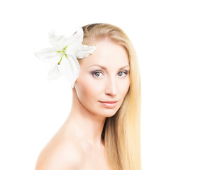 Beauty portrait of a young and natural woman with a lily flower