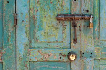 Old Brass Padlock on Wooden Green Door