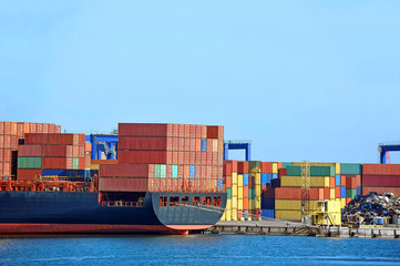 Container stack and ship under crane bridge