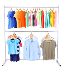 Obraz premium Different clothes on hangers, on gray background