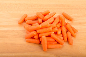 Pile of Baby Carrots on Wood Table