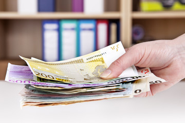 Hand holding bunch of cash