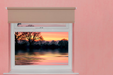 View of sunset over lake a window