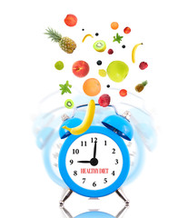Diet concept, alarm clock ringing and fruits