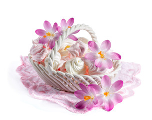Delicate meringue in a dish with blooming crocuses
