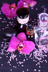 Beautiful spa setting with orchid on bamboo napkin close-up