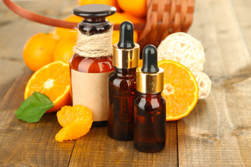 Tangerine essential oil and tangerines on wooden table