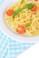 Delicious spaghetti with tomatoes on plate on table close-up