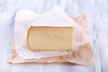 Tasty Camembert cheese with thyme, on wooden table