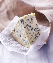 Tasty blue cheese, on wooden table