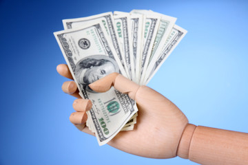 Money in wooden hand, on color background