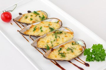 Baked Mussels under Cream Cheese Sauce, garnished with dill and
