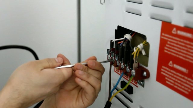 Electrician wiring appliance close-up