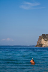 Two people swimming in the water at the beach of the Koh Ngai is