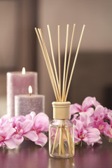 Obraz na płótnie Canvas air freshener sticks at home with flowers and ou of focus backgr