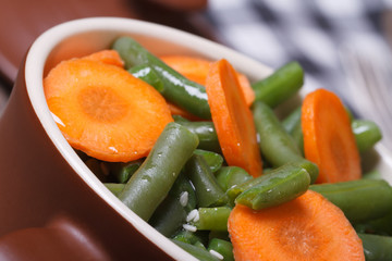 Green beans with carrots and sesame seeds close-up