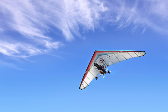 Motorized hang glider in the blue sky