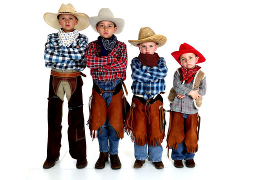 four young cowboy brothers standing with arms folded serious exp