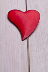 Red heart on old wooden table 
