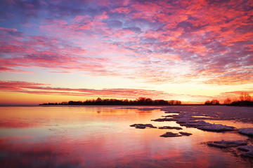 Winter landscape with sunset fiery sky. Composition of nature.