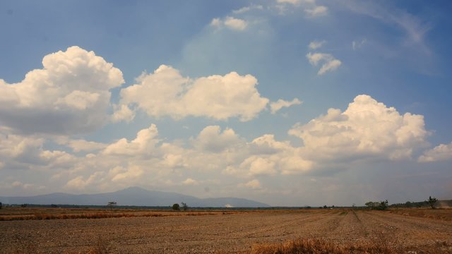 Clouds time lapse over dry grass